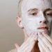 Close-up of a man applying facial cleanser for a refreshing skincare routine, focusing on self-care and health.